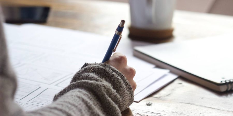 person writing, indoors