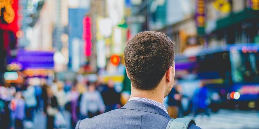 man in the city, outdoors, looking around