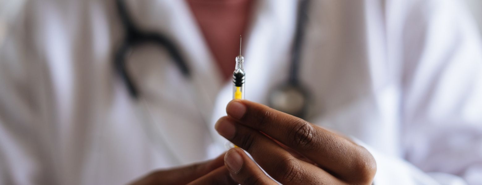 Doctor holding injection needle