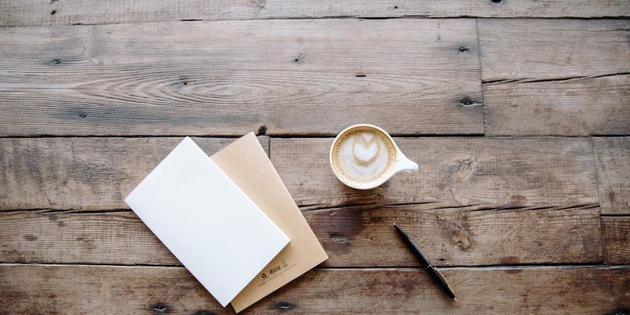 Coffee, notebooks and pen