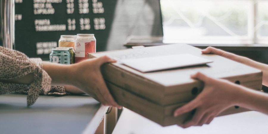 handing box to someone indoors
