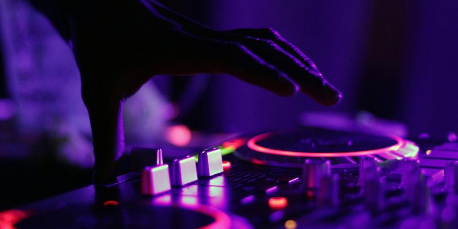 dj playing music, in dark, indoors