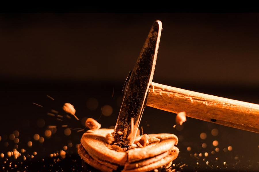 a hammer smashing an object on a table