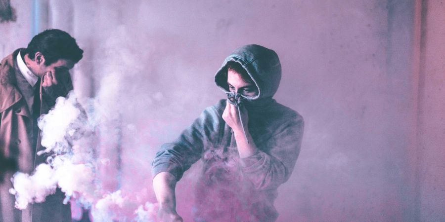 covering face, smoke around