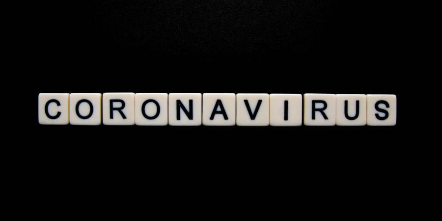 coronavirus letters over a black background