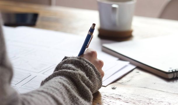 person writing, indoors