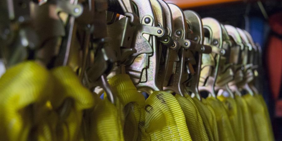 safety clips hanging on a rack indoors