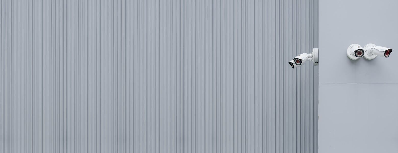 outdoors wall, with white cameras mounted