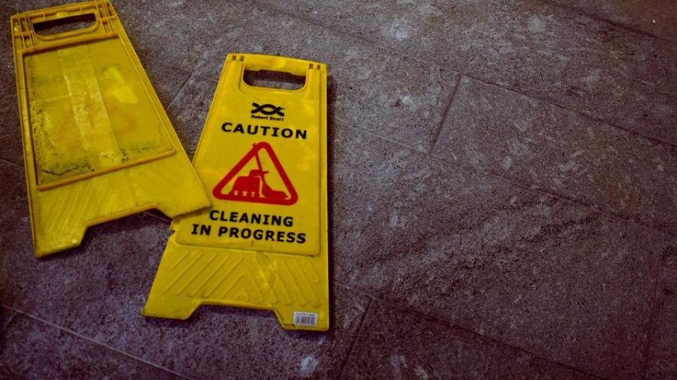 yellow caution cleaning sign, indoors, on the floor