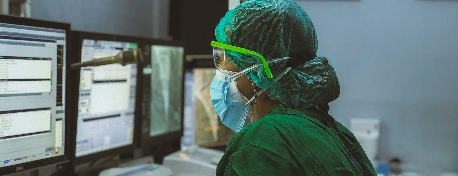 nurse working on a computer inside a hospital