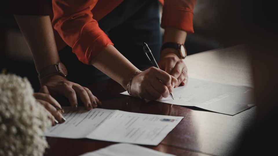 women signing contracts