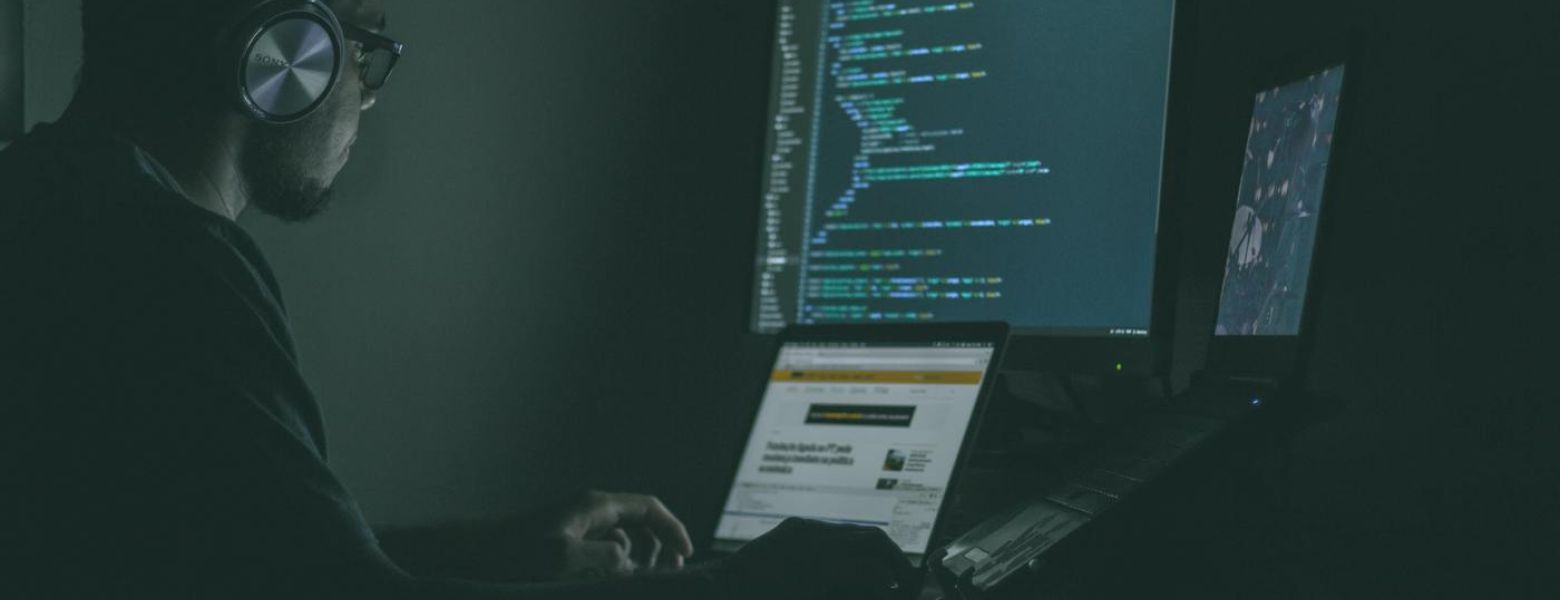 man using a computer in a dark room