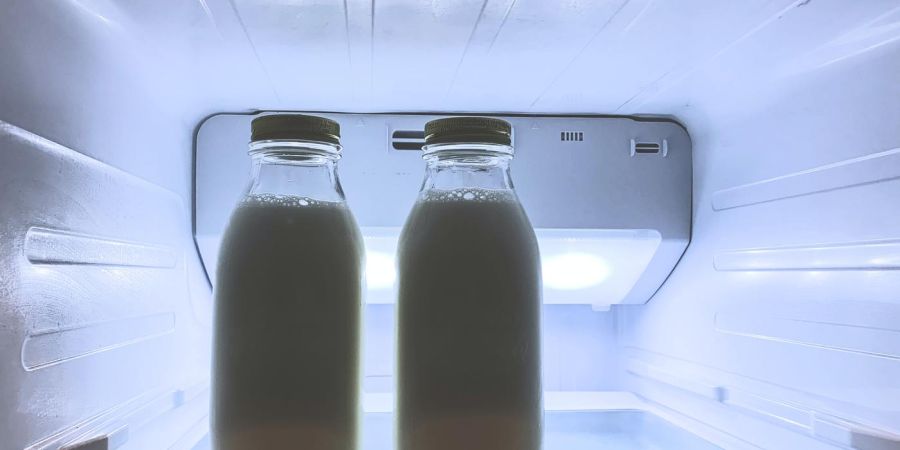 milk in jars inside a refrigerator