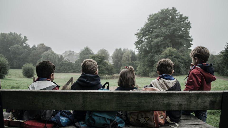 children sitting on a bench