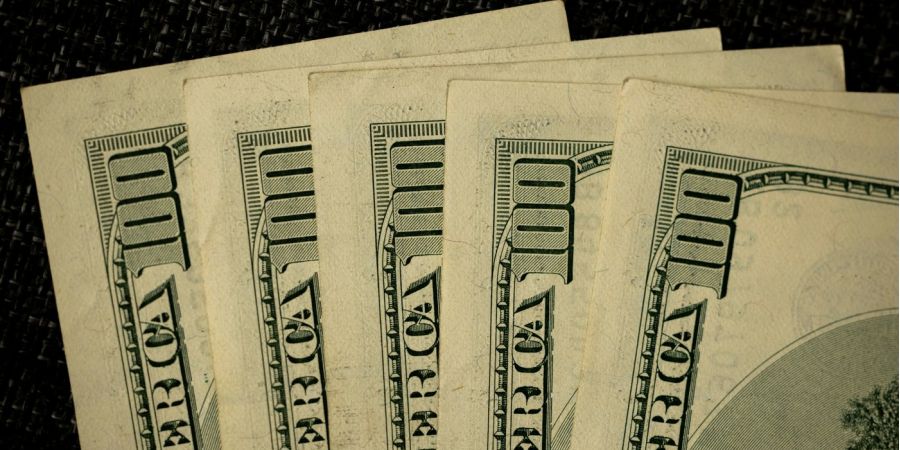 hundred dollar bills in a fan shape