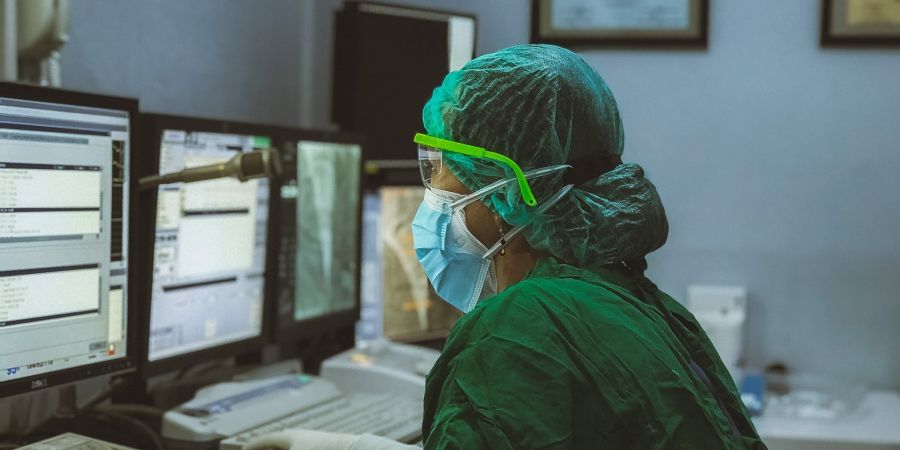 nurse working on a computer inside a hospital