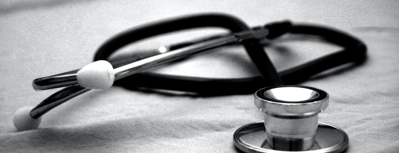 medical stethoscope sitting on a clothe table indoors