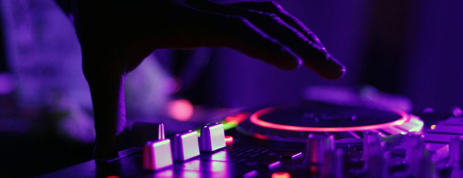dj playing music, in dark, indoors