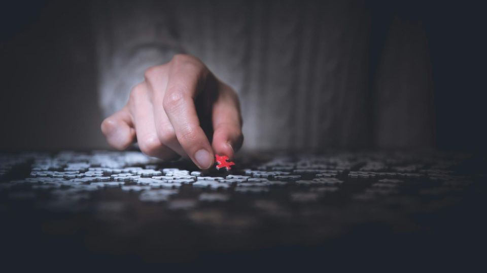 red puzzle piece being placed