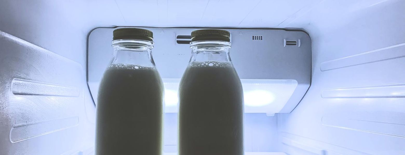 milk in jars inside a refrigerator