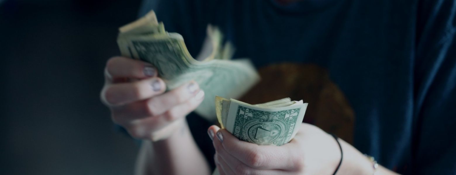 woman counting money dollar bills