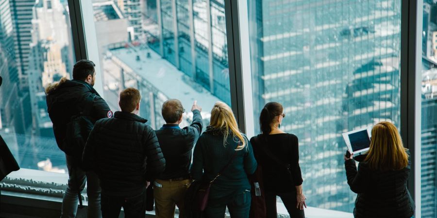 group of people inside a skyscraper looking outside