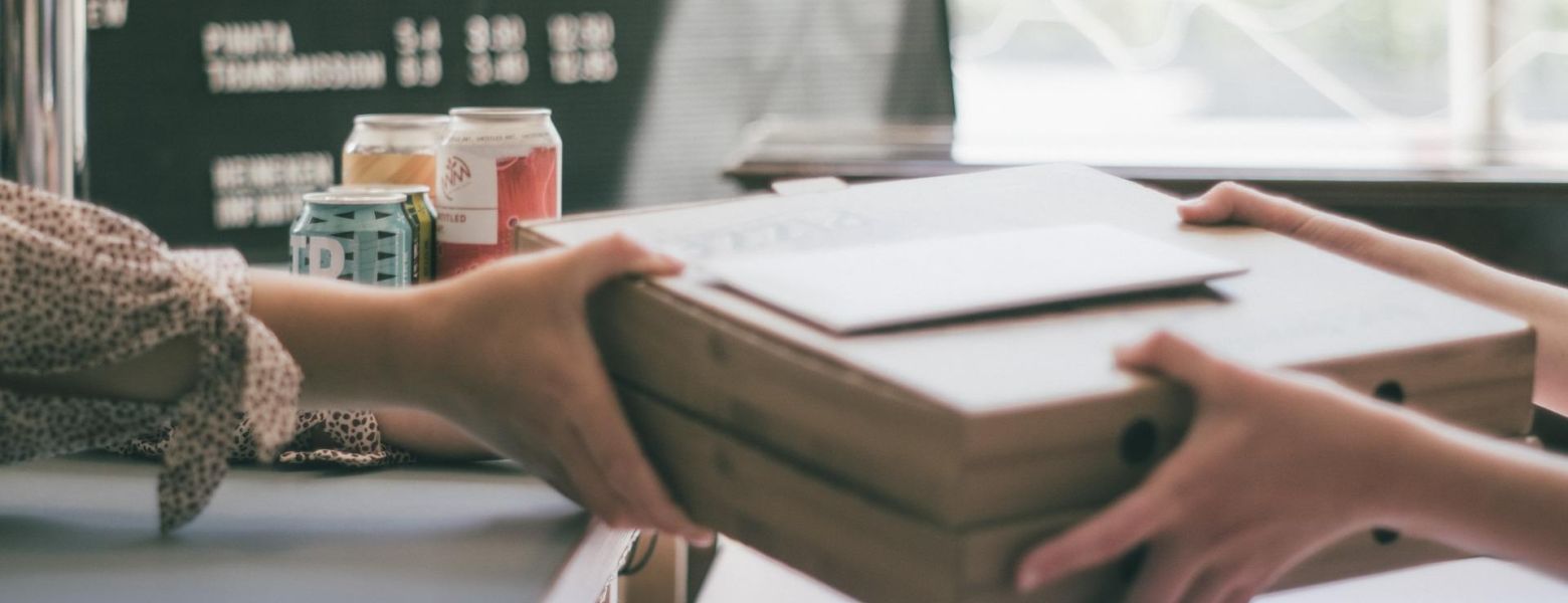 handing box to someone indoors