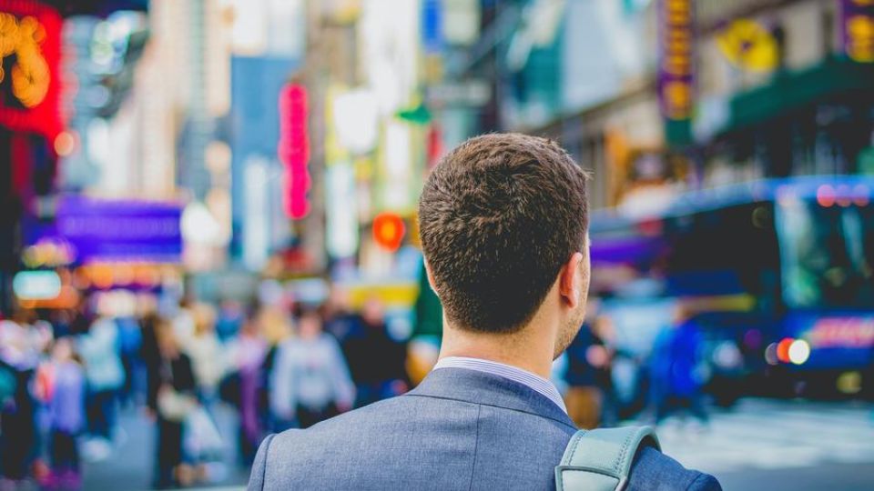 man in the city, outdoors, looking around