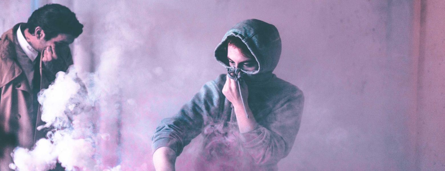 covering face, smoke around