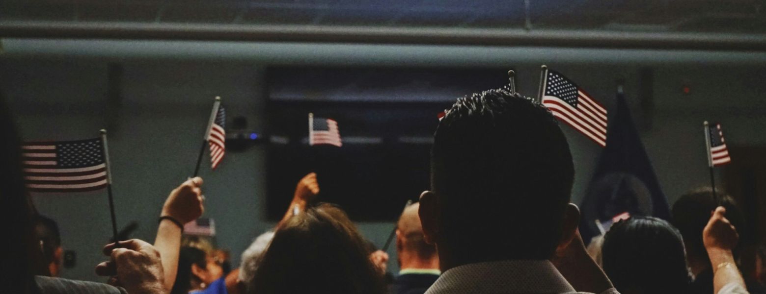 group of people indoors, holding little flags