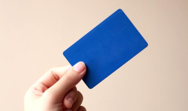 a person holding a blue card, indoors
