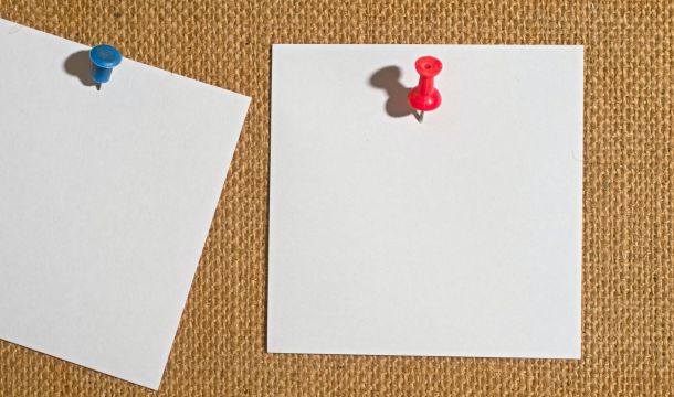 papers pinned to cloth backdrop