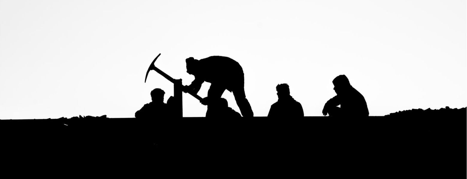 group of people laboring outdoors, silhouette