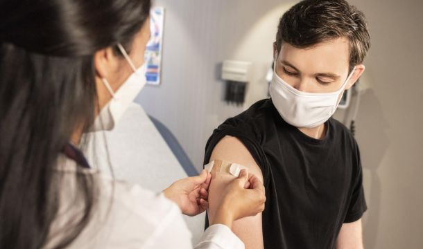 doctor placing a bandaid on a patient, indoor, patient room