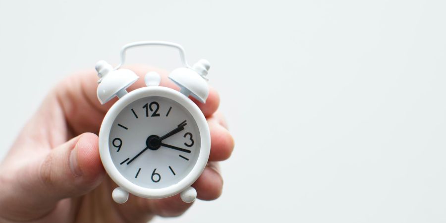 holding a tiny clock