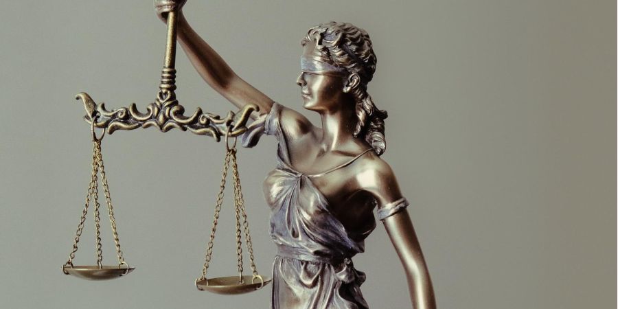 bronze statue of the balance of law, indoors