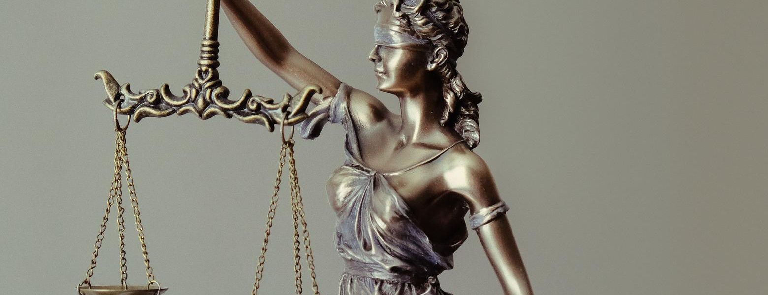 bronze statue of the balance of law, indoors