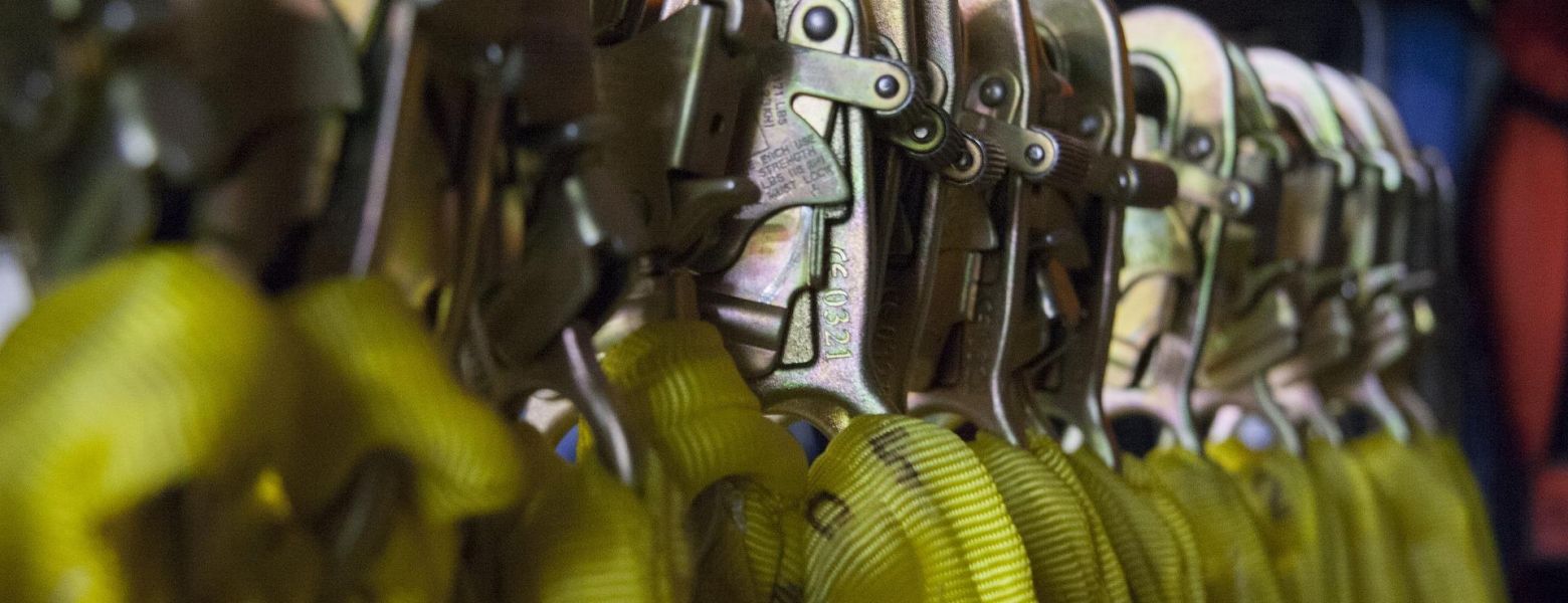 safety clips hanging on a rack indoors