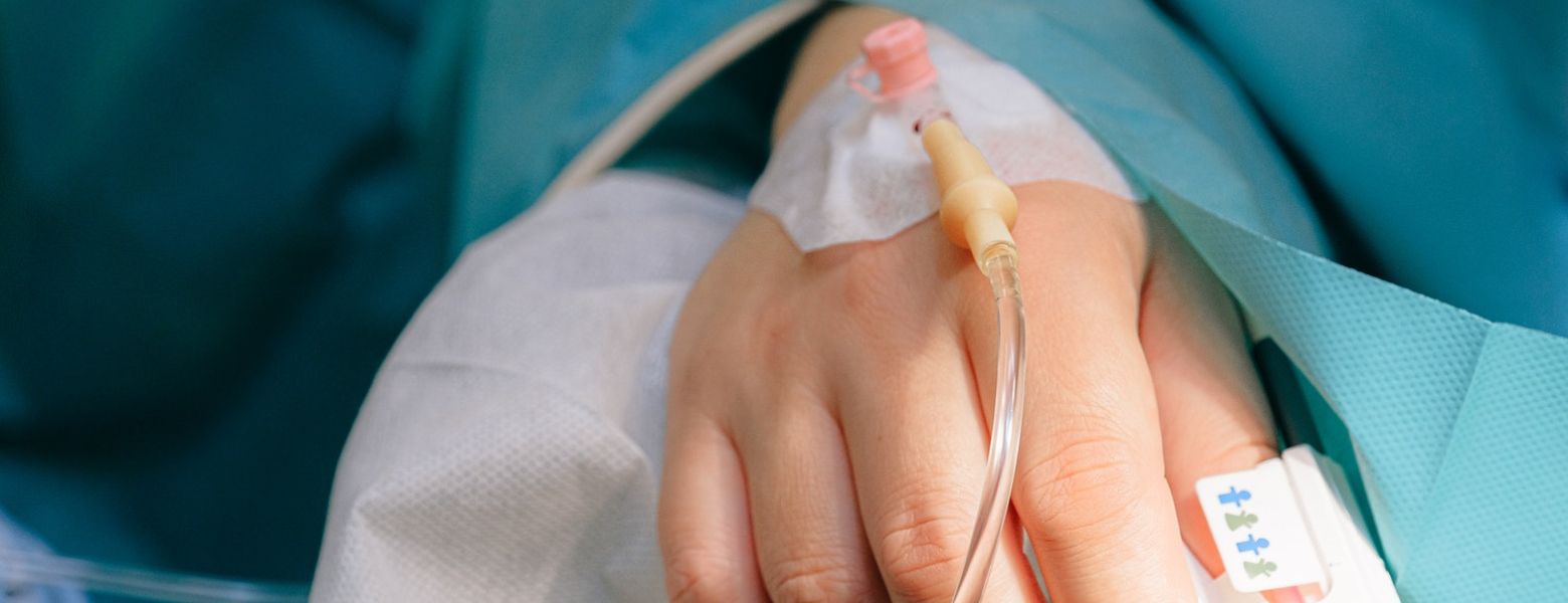 Patient indoors with an IV line