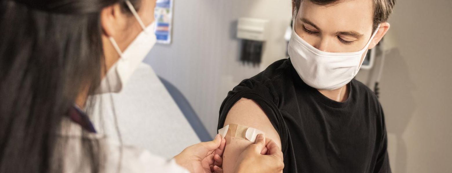 doctor placing a bandaid on a patient, indoor, patient room