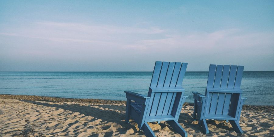 two chairs on the beach at ocean, outdoors