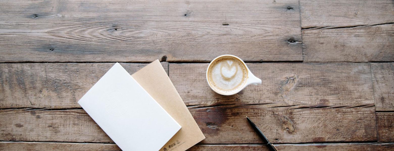 Coffee, notebooks and pen