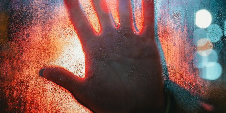 hand on window while raining