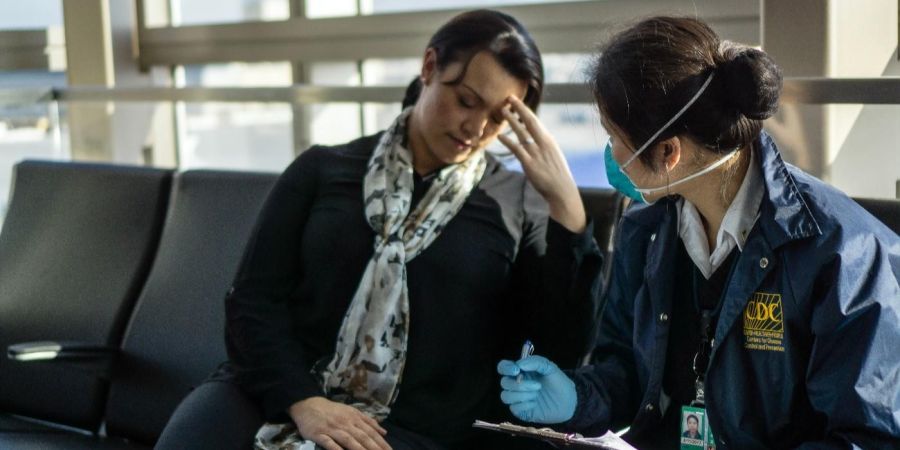 CDC interviewing a sick person inside an airport
