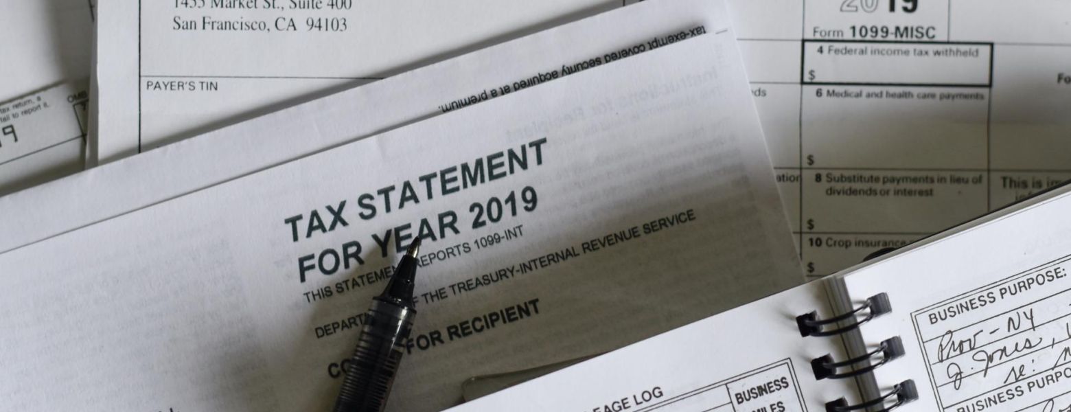 irs documents piled with a pen, indoors