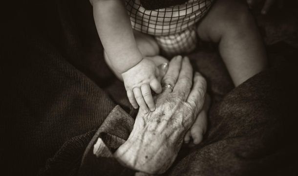 grandma reaching out to hold great grandson
