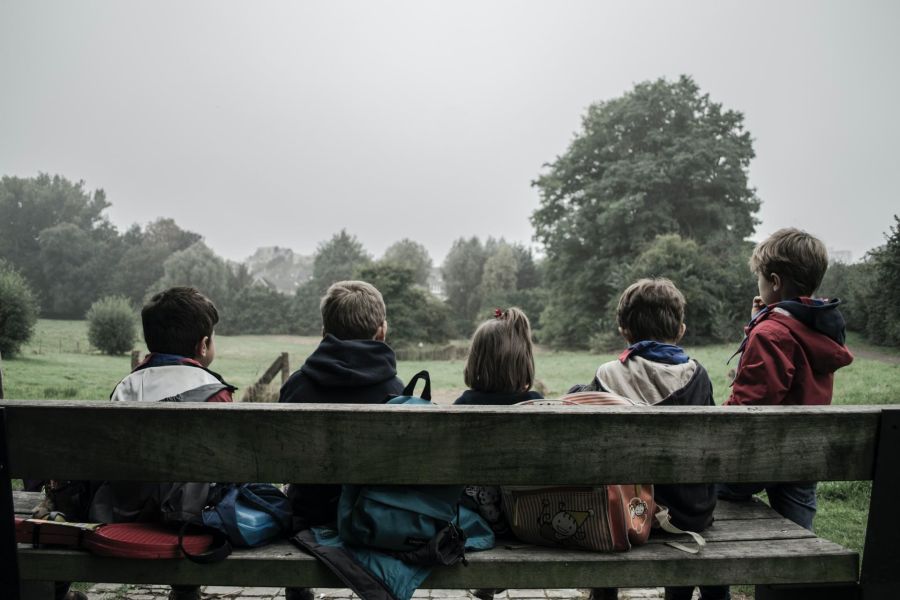 children sitting on a bench