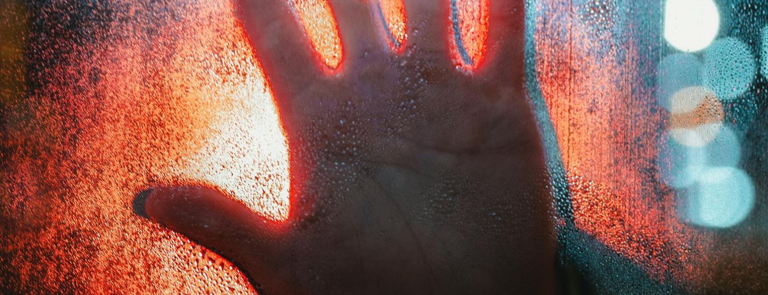 hand on window while raining