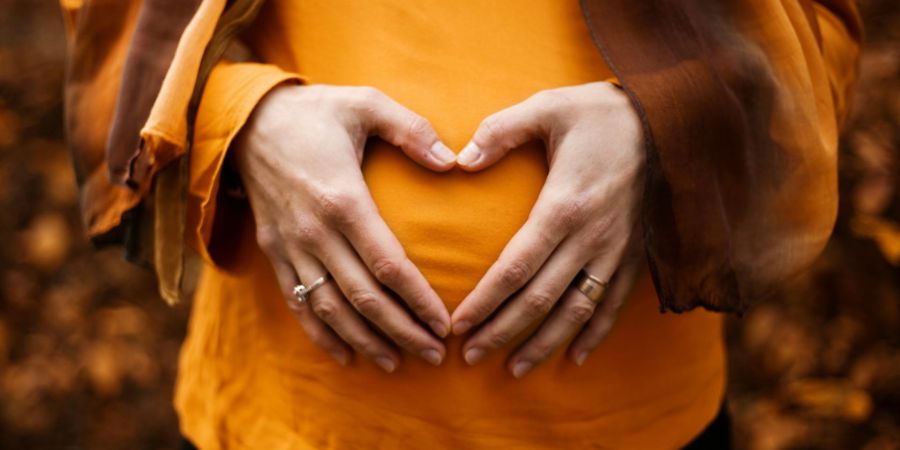 pregnant lady in orange outdoors