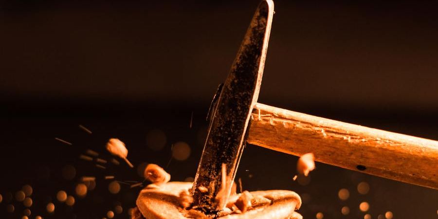 a hammer smashing an object on a table